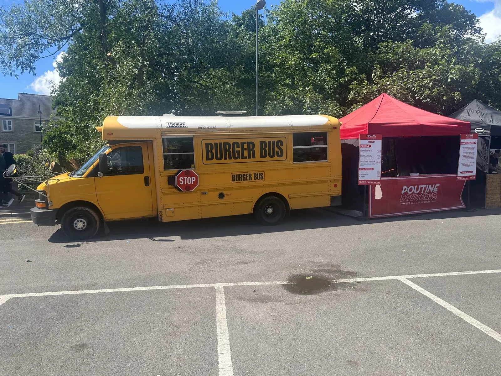 Burger Bus and the Poutine Brothers stall set up side by side at an event