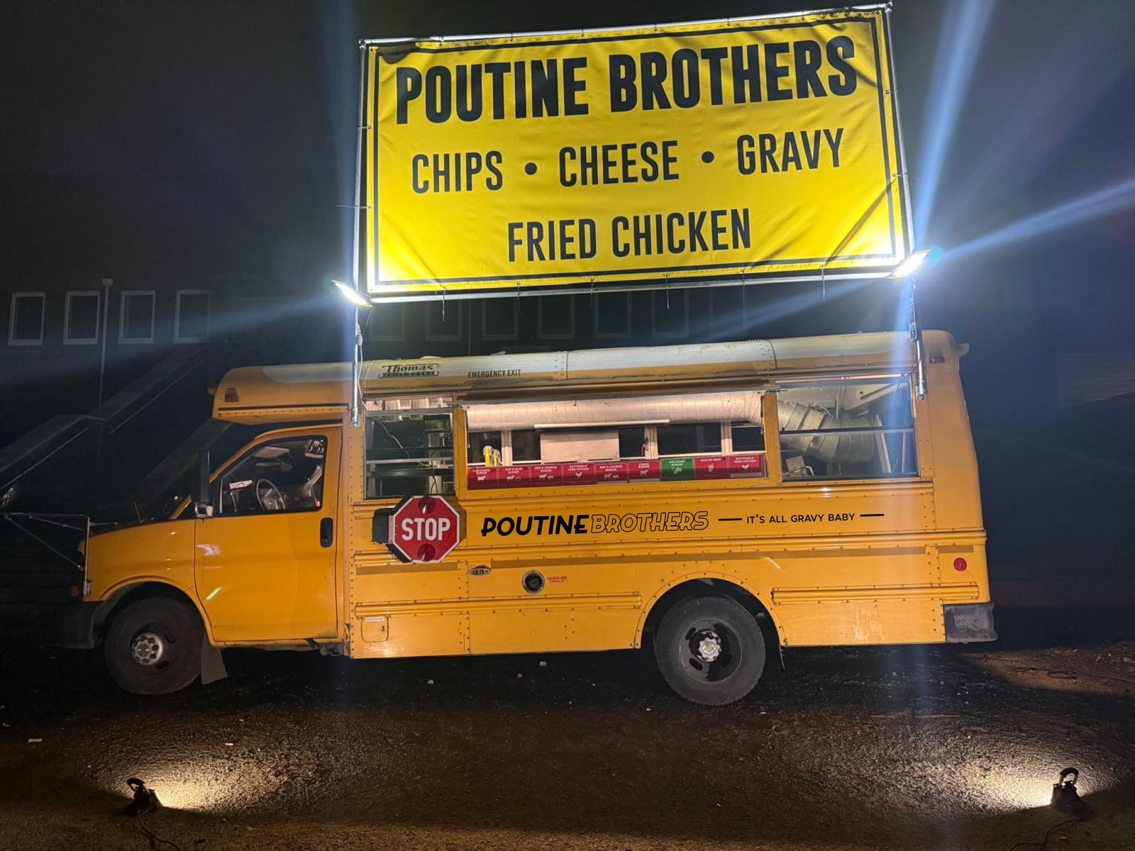 Poutine Brothers bus lit up at night